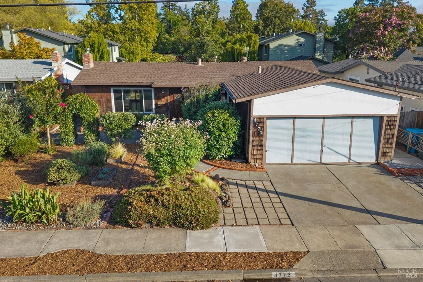 Street view of 4772 Sunshine Avenue with landscaped front yard