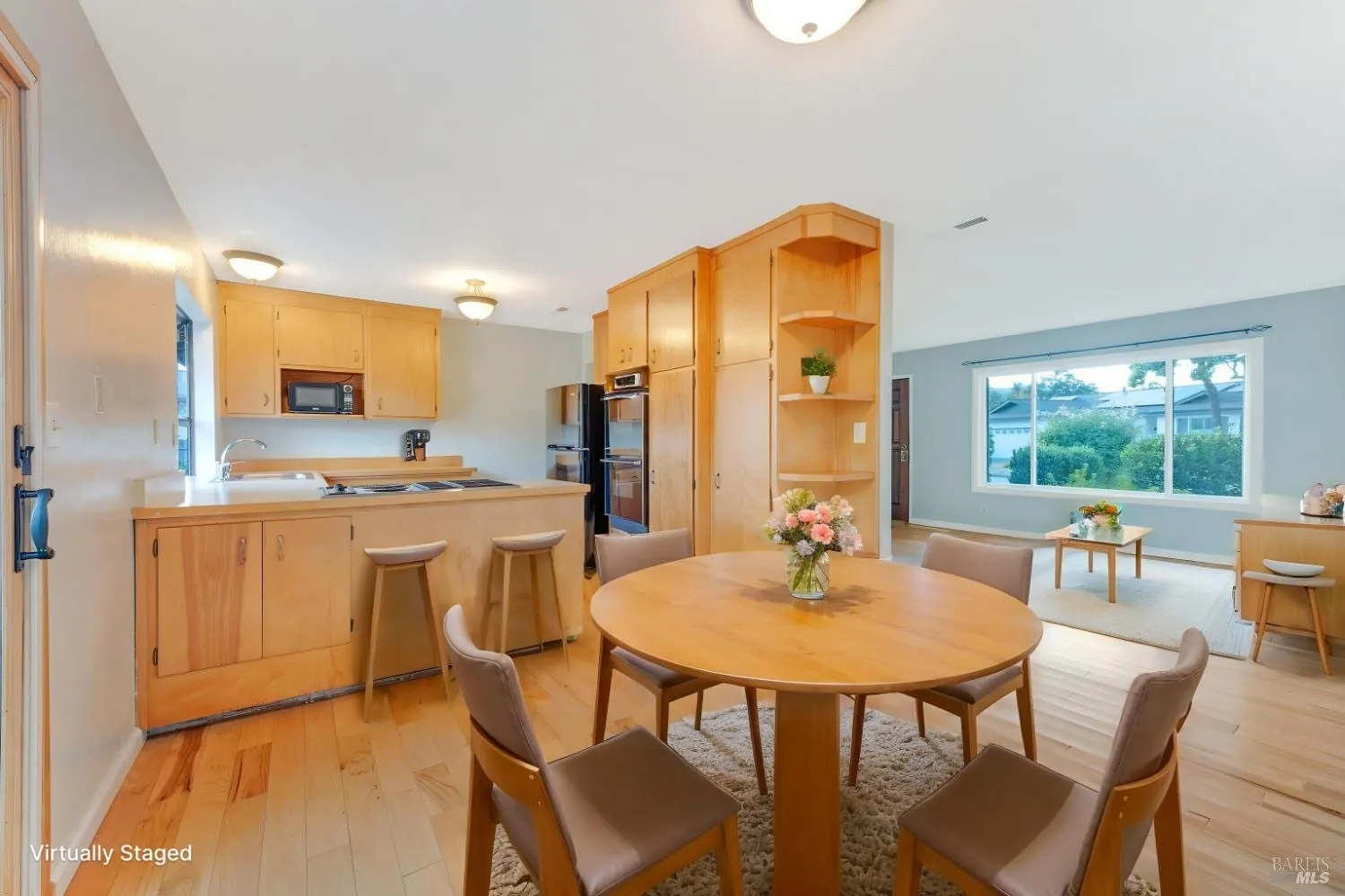 Open kitchen and dining area with wood cabinetry