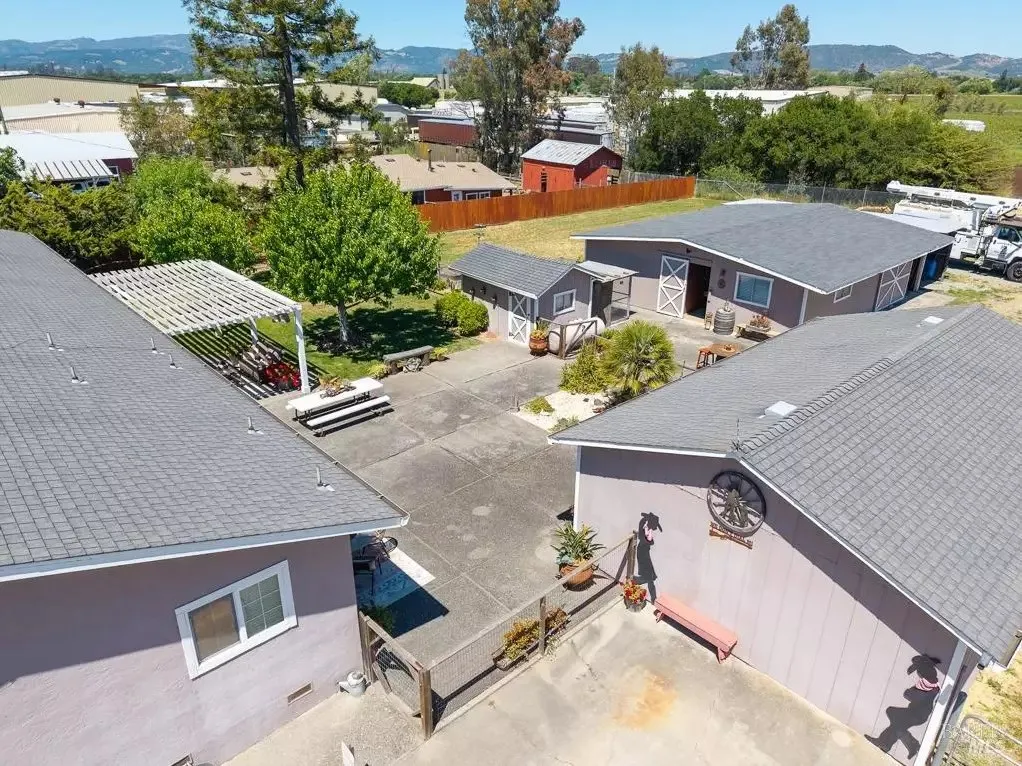 Aerial view of the courtyard, outbuildings, and hills beyond