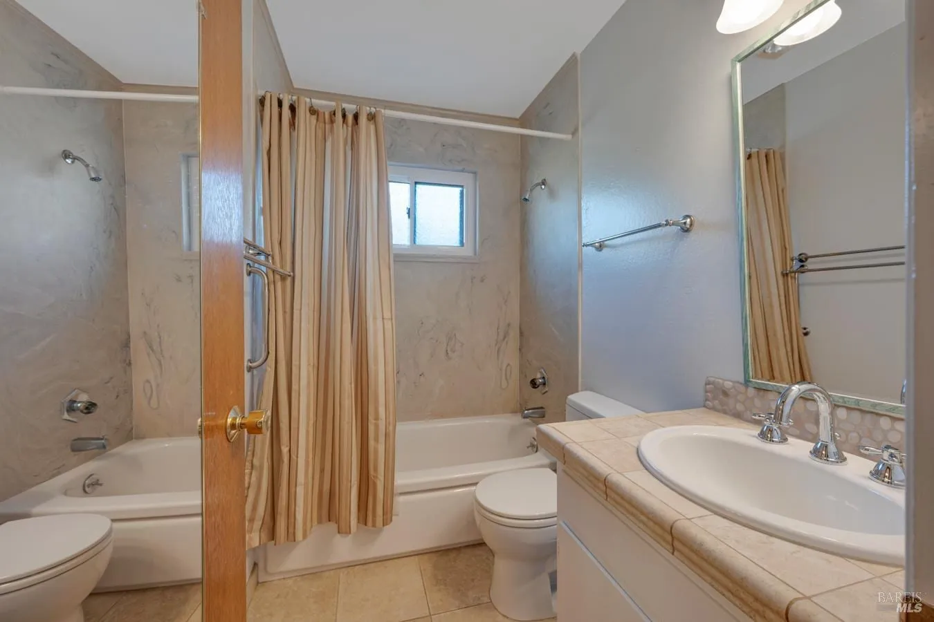 Bathroom with tiled vanity and tub shower
