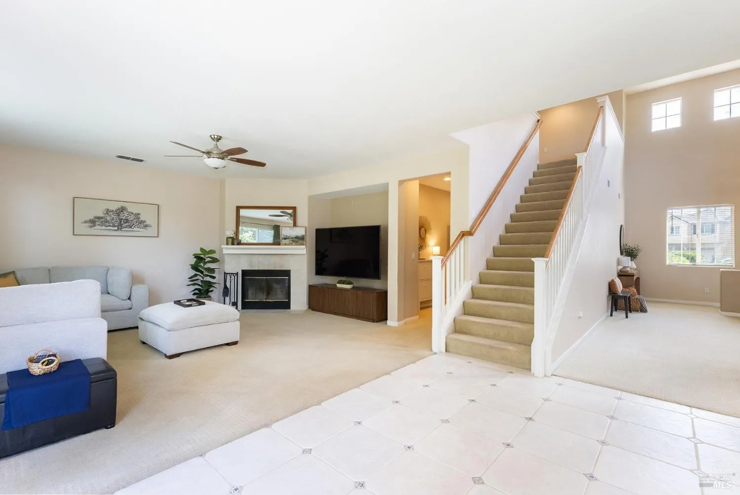 Family room with fireplace, media niche, and staircase