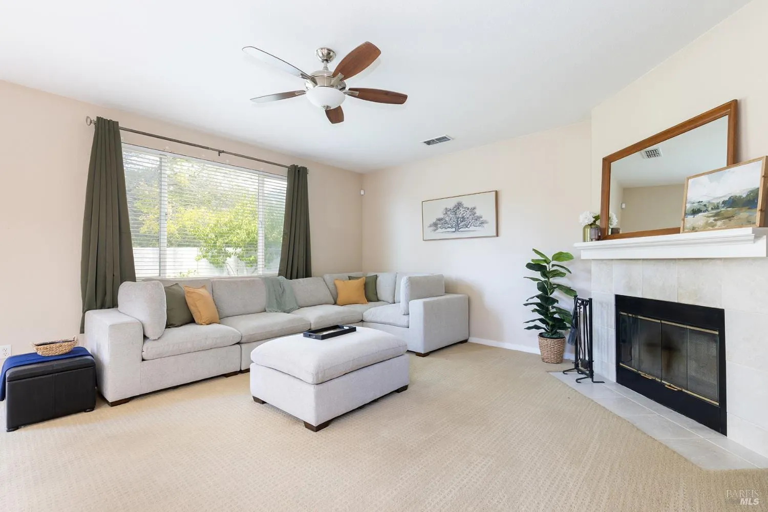 Family room sectional seating beside the tiled fireplace